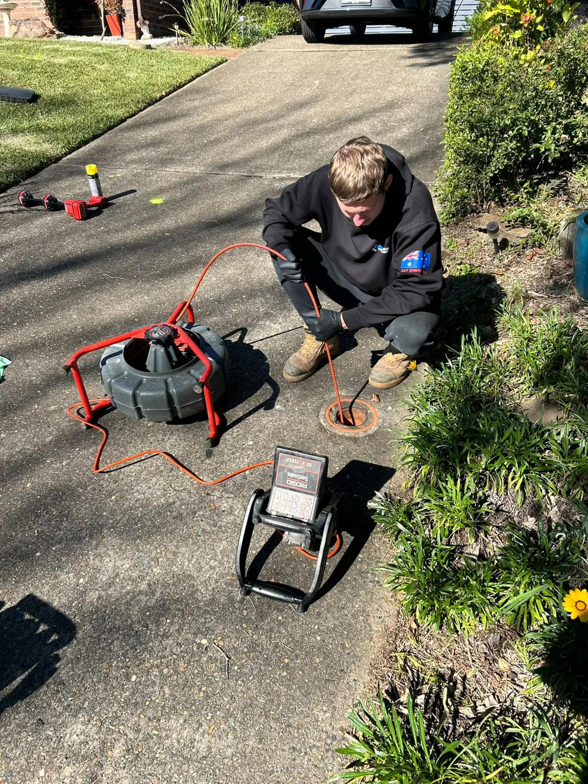 CCTV drain camera and toolkit set up on a driveway