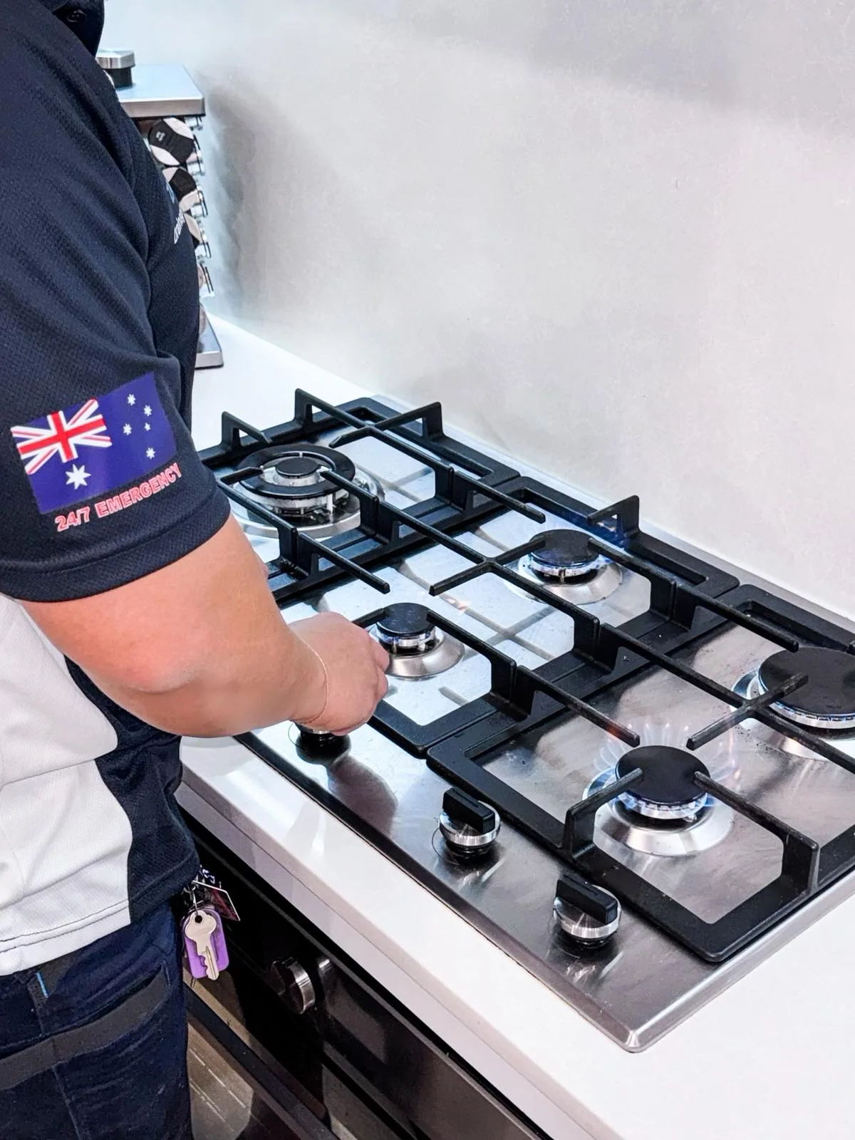 A plumber connecting a gas cooktop